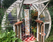 A hand-painted silk scarf in tiny greenhouse with the flowers that inspired the painting